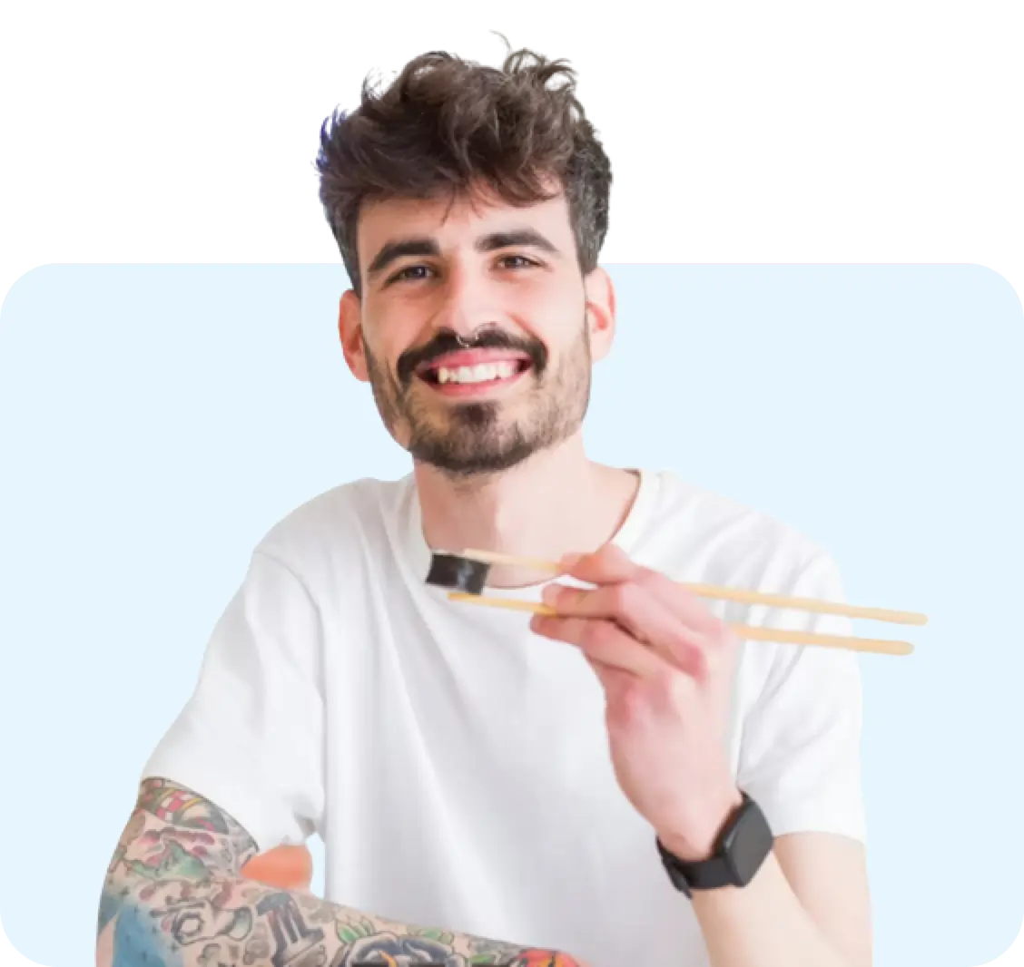 A man eating sushi with chopsticks.